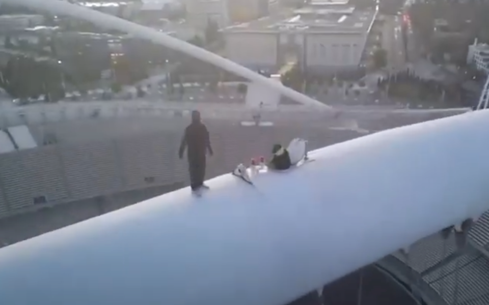 Daredevils climb roof of Athens Olympic Stadium